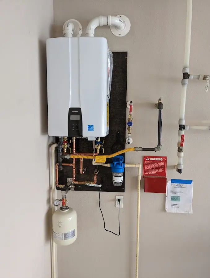 Professional plumber installing copper piping in a Hornell home